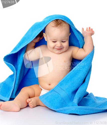 Image of Cute child wrapped in blue towel