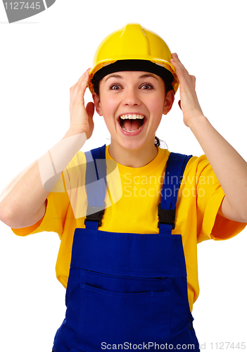 Image of Construction girl holds her hard hat and scream