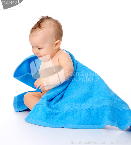 Image of Cute child wrapped in blue towel