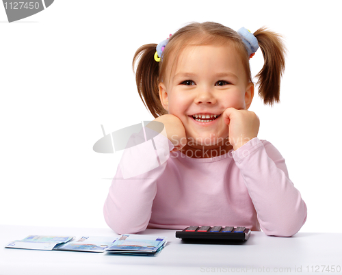 Image of Little girl with few paper euro banknotes