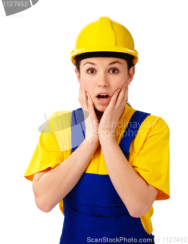 Image of Construction girl holding her face in astonishment