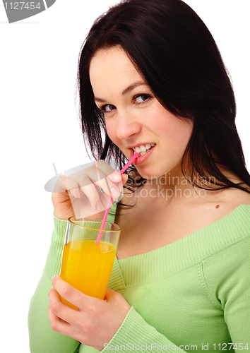 Image of Young attractive woman drinks orange juice