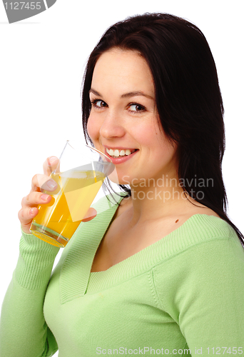 Image of Young attractive woman drinks orange juice