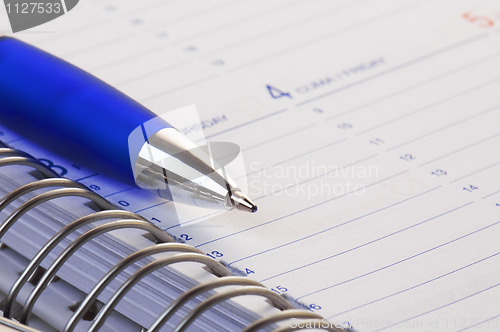 Image of pencil on opened a notebook