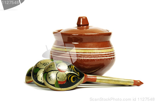 Image of Clay pot with wooden spoons 