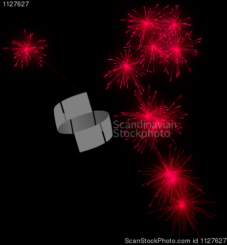 Image of Festive red fireworks at night