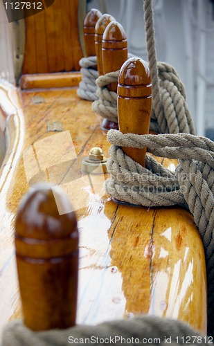 Image of Ropes and polished wood on the deck of an old ship