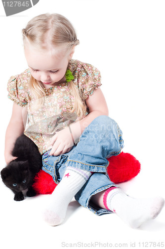 Image of Little girl playing with kitten