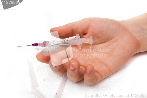 Image of Syringe in a palm of the addict