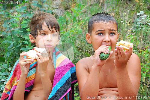 Image of kids having dinner outdoor