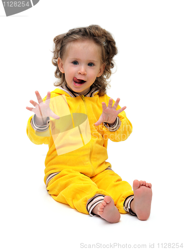 Image of fun little girl in yellow sitting