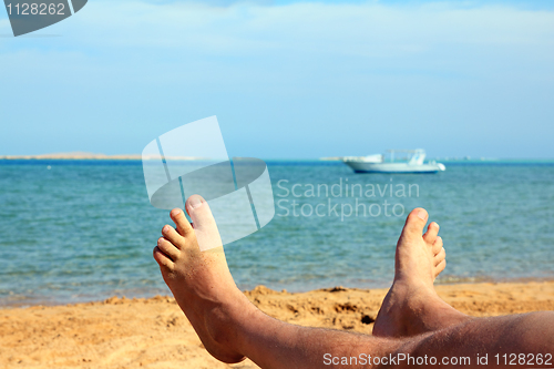 Image of man foots on beach