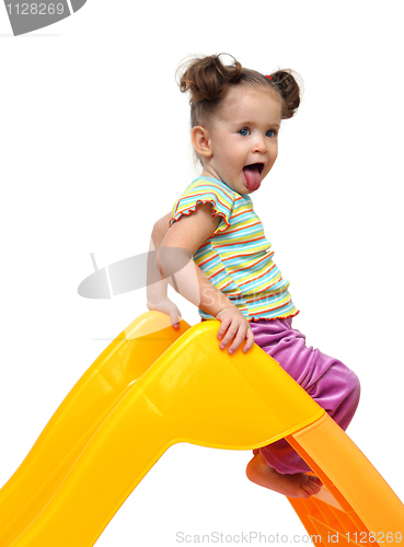 Image of cute little girl on yellow slide