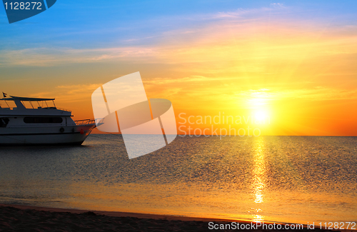 Image of ship at anchor and sunrise over sea