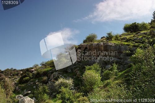 Image of Steep weathered cliff face in bright spring day