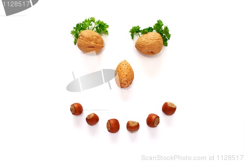 Image of smiling face made whith help of nuts