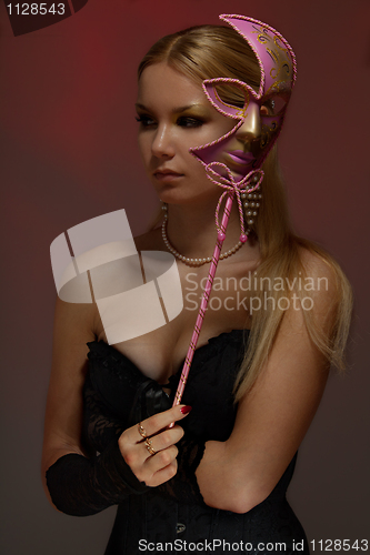 Image of Lady at masquerade with pink mask