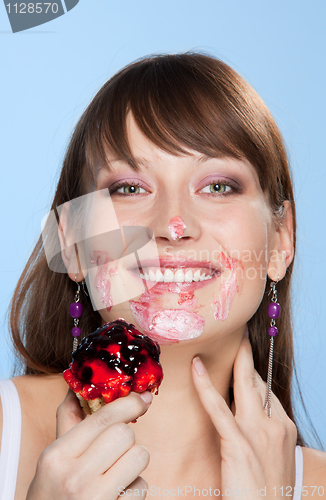 Image of Happy girl with her face smear in cake