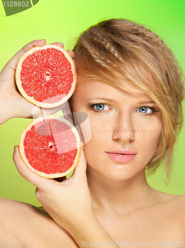 Image of Portrait of  young attractive woman with grapefruit