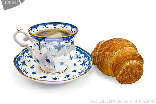 Image of Coffee in a cup with a blue pattern and croissant