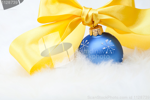 Image of Christmas ball with yellow ribbon bow