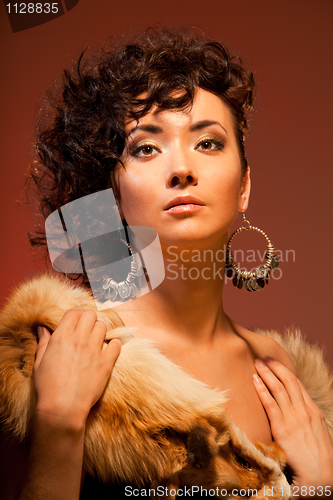 Image of gorgeous Asian woman with curly hairstyle
