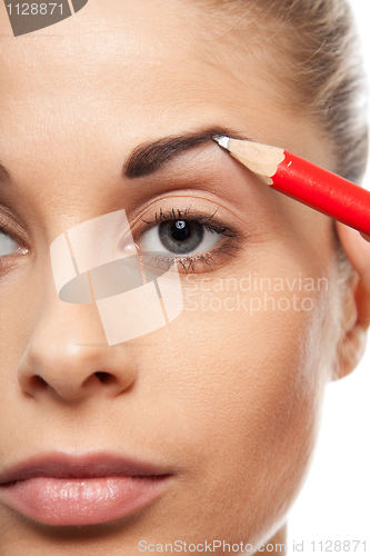 Image of Pencil woman's eyebrows with a carpenters pen