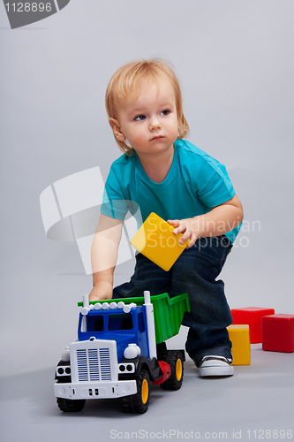 Image of Kid playing with cars