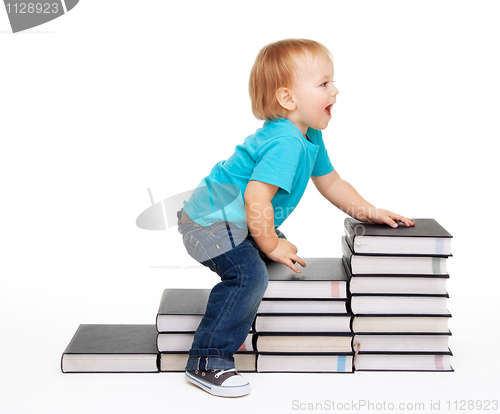 Image of A kid on a steps of books