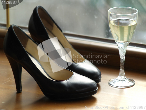 Image of Female Shoes and Glass of Wine