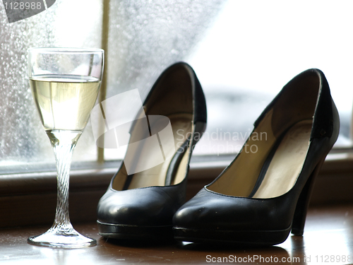 Image of Female Shoes and Glass of Wine