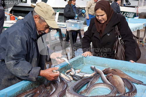 Image of MARSEILLE, FRANCE, MARCH 6: a fish salesman on the open-air market of the Vieux-port, on Sunday, March 6th, 2011, in Marseille, France