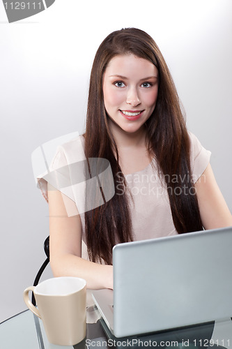 Image of Businesswoman working on a laptop