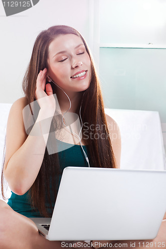 Image of Woman listening to music