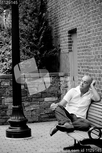 Image of Casual Guy Sitting on a City Bench