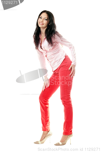 Image of Smiling brunette in red jeans