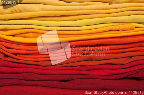 Image of Folded red, orange and yellow clothes