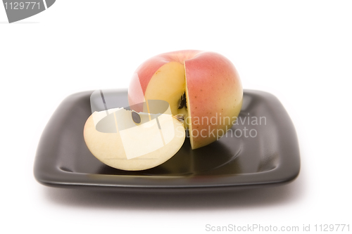 Image of Apple and segment on a plate