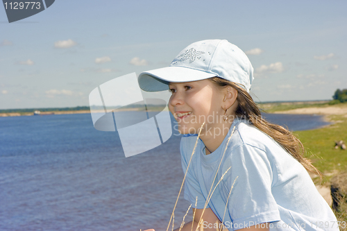 Image of The girl on river bank
