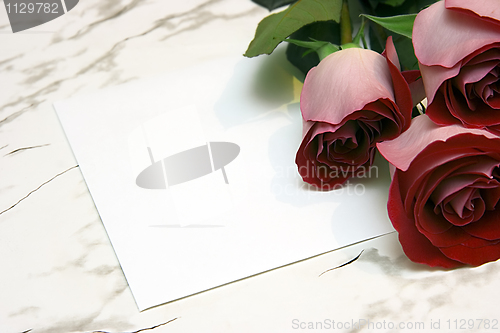 Image of Three red roses and note