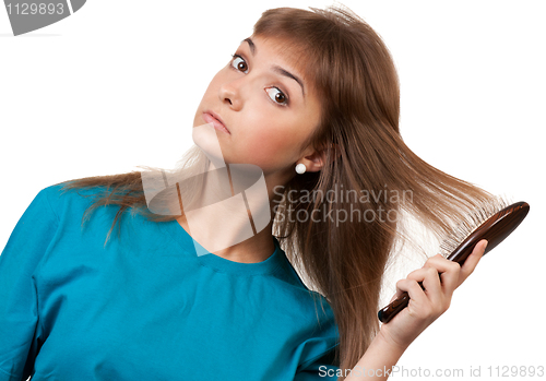 Image of young beautiful girl is combed