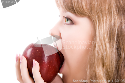 Image of The girl bites an apple