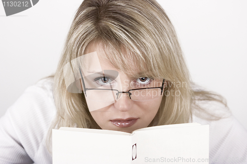 Image of The girl hides behind the book