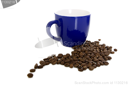Image of Dark blue mug and scattered coffee