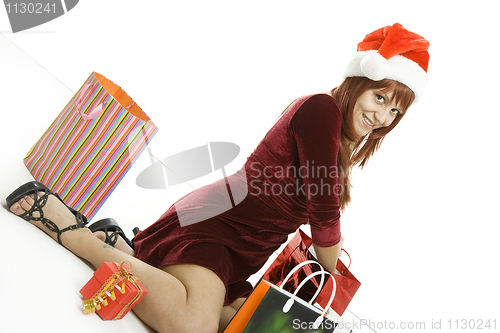 Image of The girl in a Christmas cap with purchases