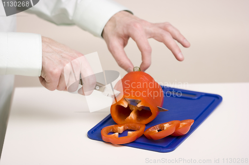 Image of The man cuts sweet pepper