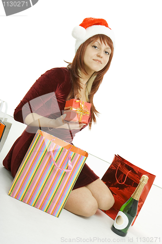Image of The girl in a Christmas cap with purchases