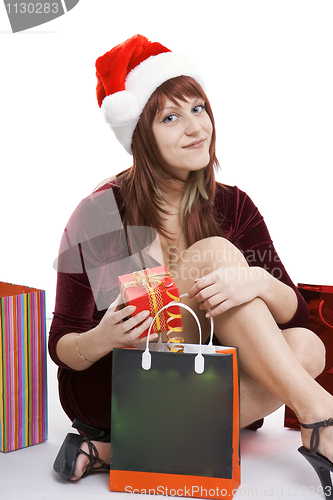 Image of The girl in a Christmas cap with purchases