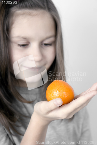 Image of The girl and a tangerine