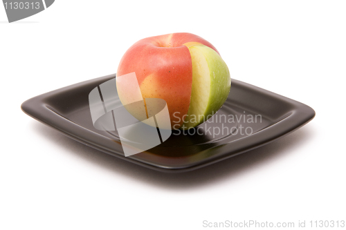 Image of Apple and segment on a plate